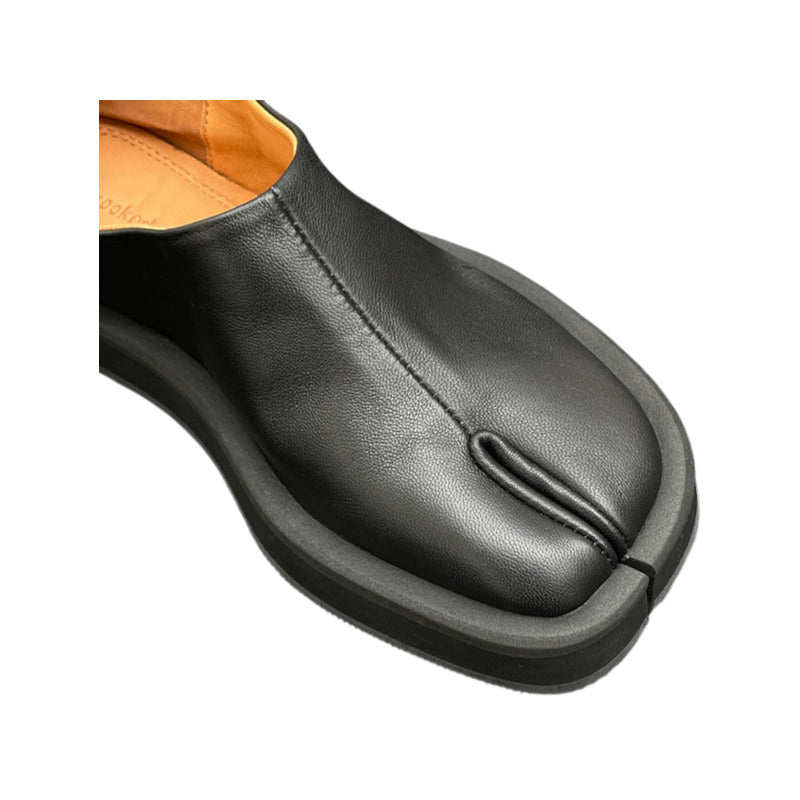Black leather shoe with a white background