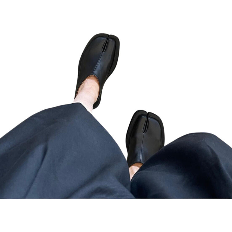 Black shoes and navy pants on a white background