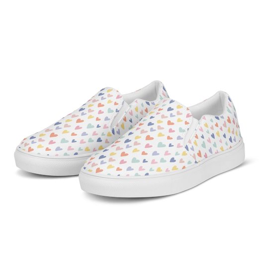 Made with a 100% polyester canvas upper, breathable lining, soft removable insole, elastic side accents, padded collar and tongue, and EVA rubber outsole. Designed with white soles and a slip-on silhouette. Finished with an all-over pastel hearts sublimation print.